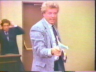 [Hammer pointing gun at defense attorney]