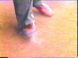 [red shoes still smoking from gunshot]