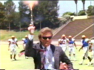 [Hammer shooting gun on football field]