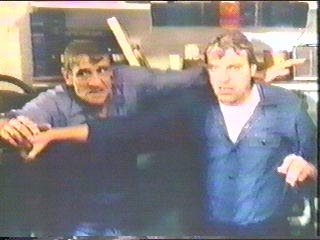 [Clive and Sledge wet after being hosed]