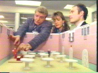 [Hammer flicking head off paper archbishop figure]