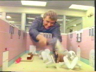 [Hammer smashing paper Dash figure with gun]