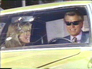 [Sledge and Doreau in car]