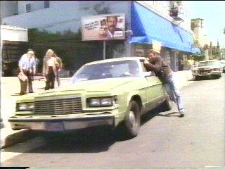 [crook handcuffed to moving car]