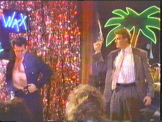 [Sledge firing gun as man dances]